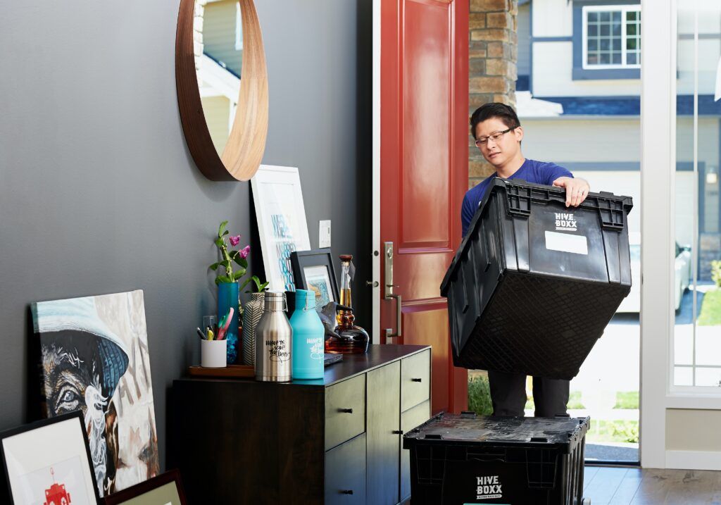 A man moving boxes in to his home when it's time to move